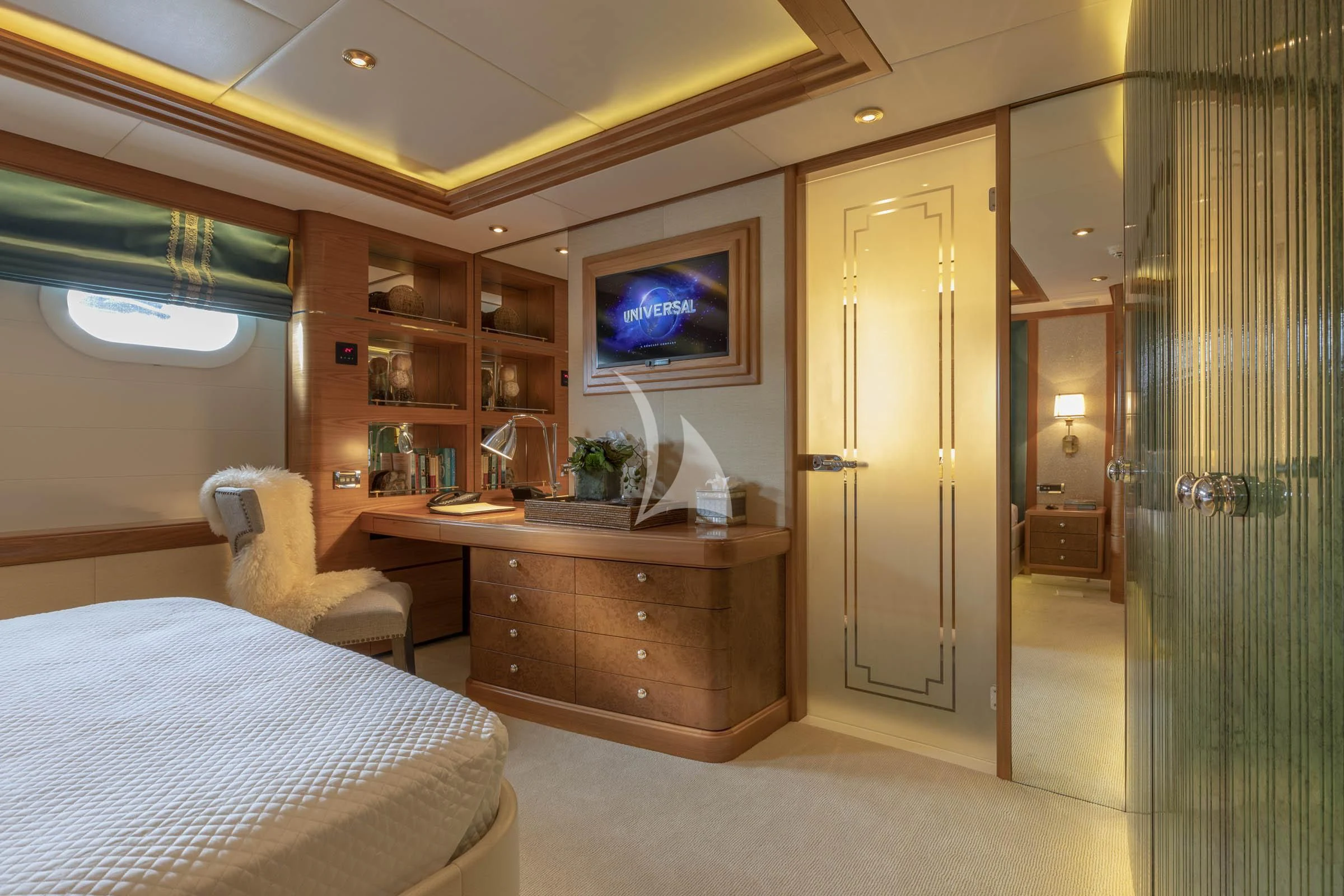 a room with a bed and a tv on the wall aboard VIBRANCE Yacht for Sale