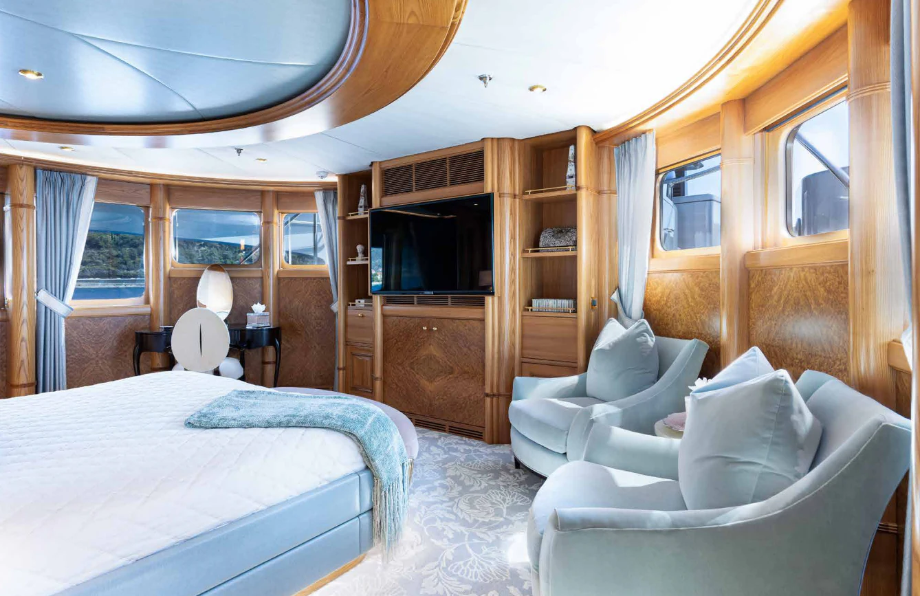 a bedroom with a bed and a tv aboard VIBRANCE Yacht for Sale