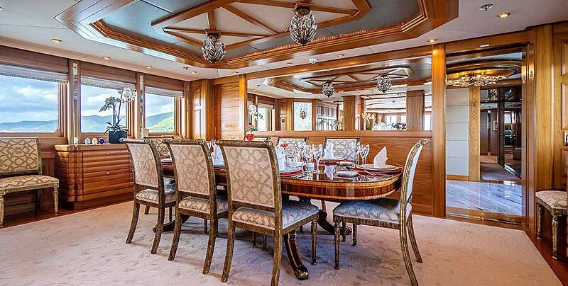 a dining room with chairs and a table aboard VIBRANCE Yacht for Sale
