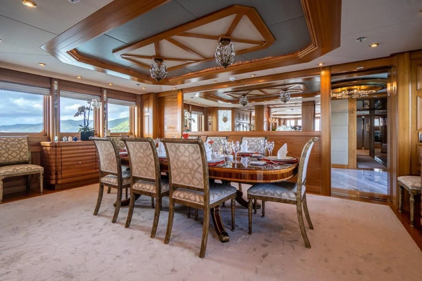 a dining room with wood furniture aboard VIBRANCE Yacht for Sale
