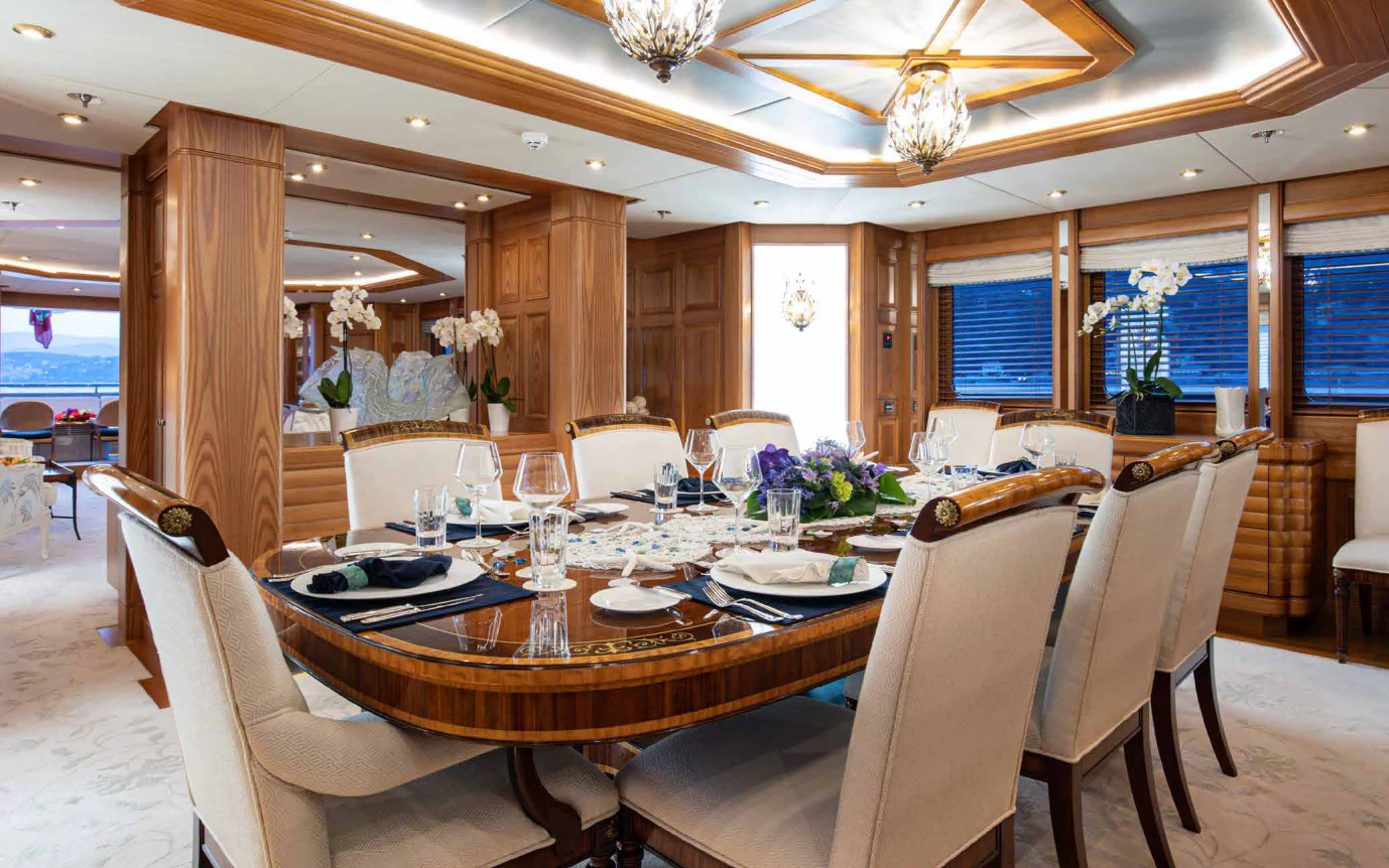 a dining room with a table set aboard VIBRANCE Yacht for Sale