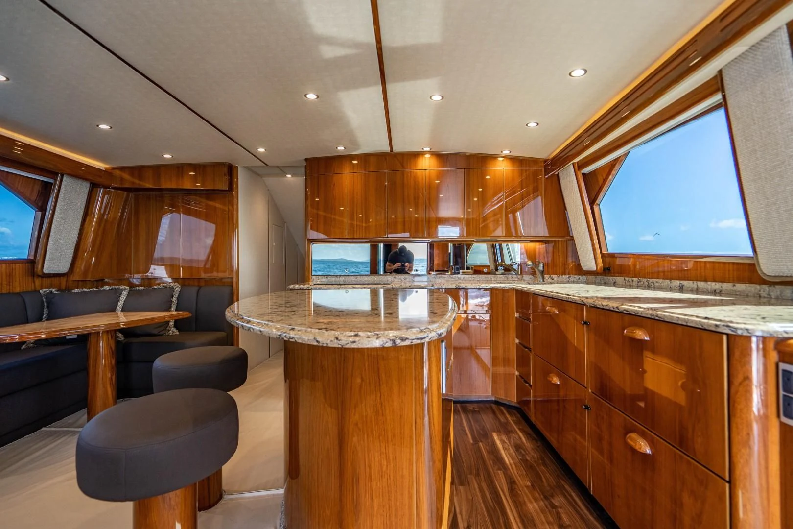 a large kitchen with wooden cabinets aboard PLAN B Yacht for Sale
