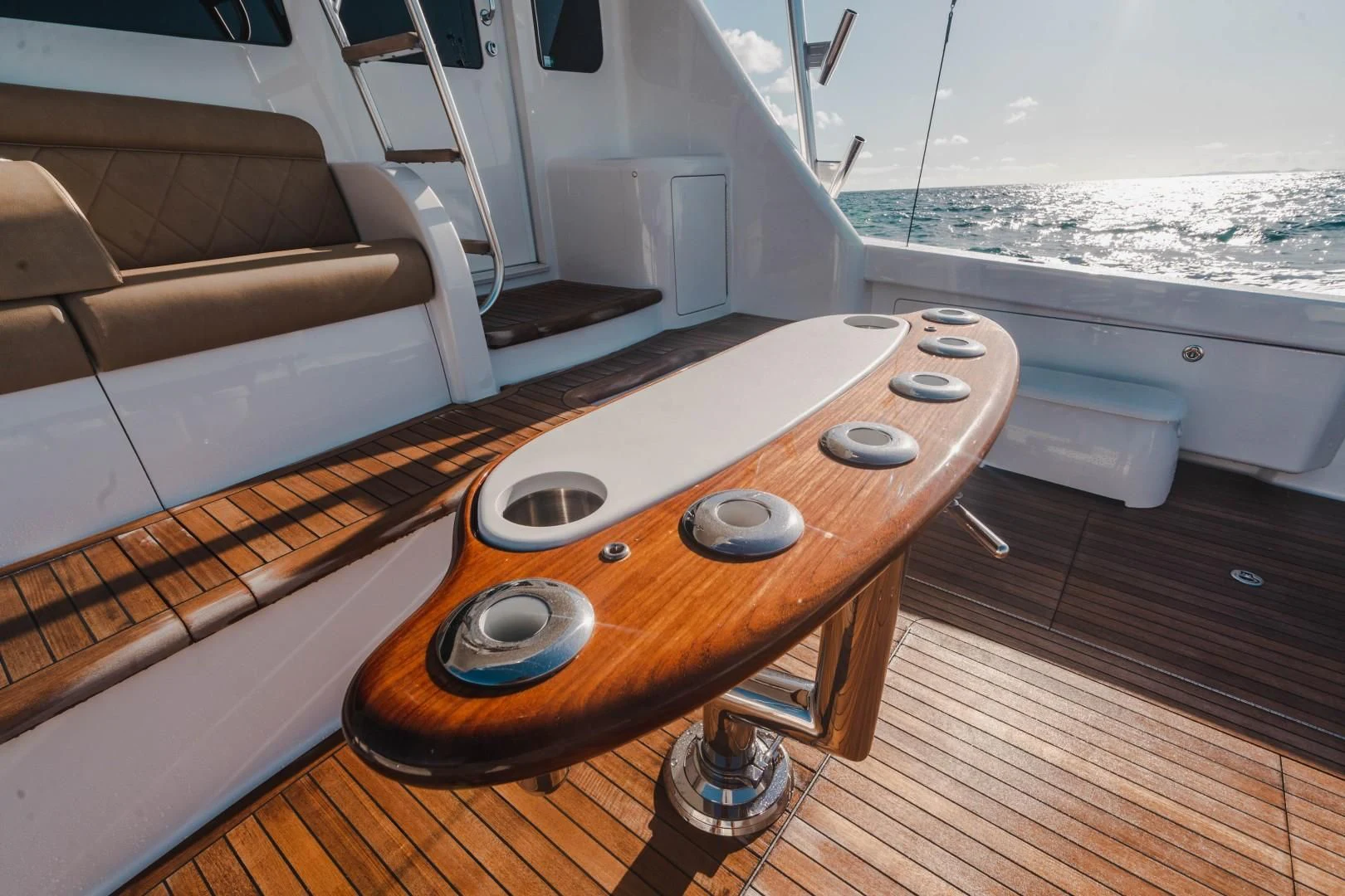 a wood table on a deck aboard PLAN B Yacht for Sale