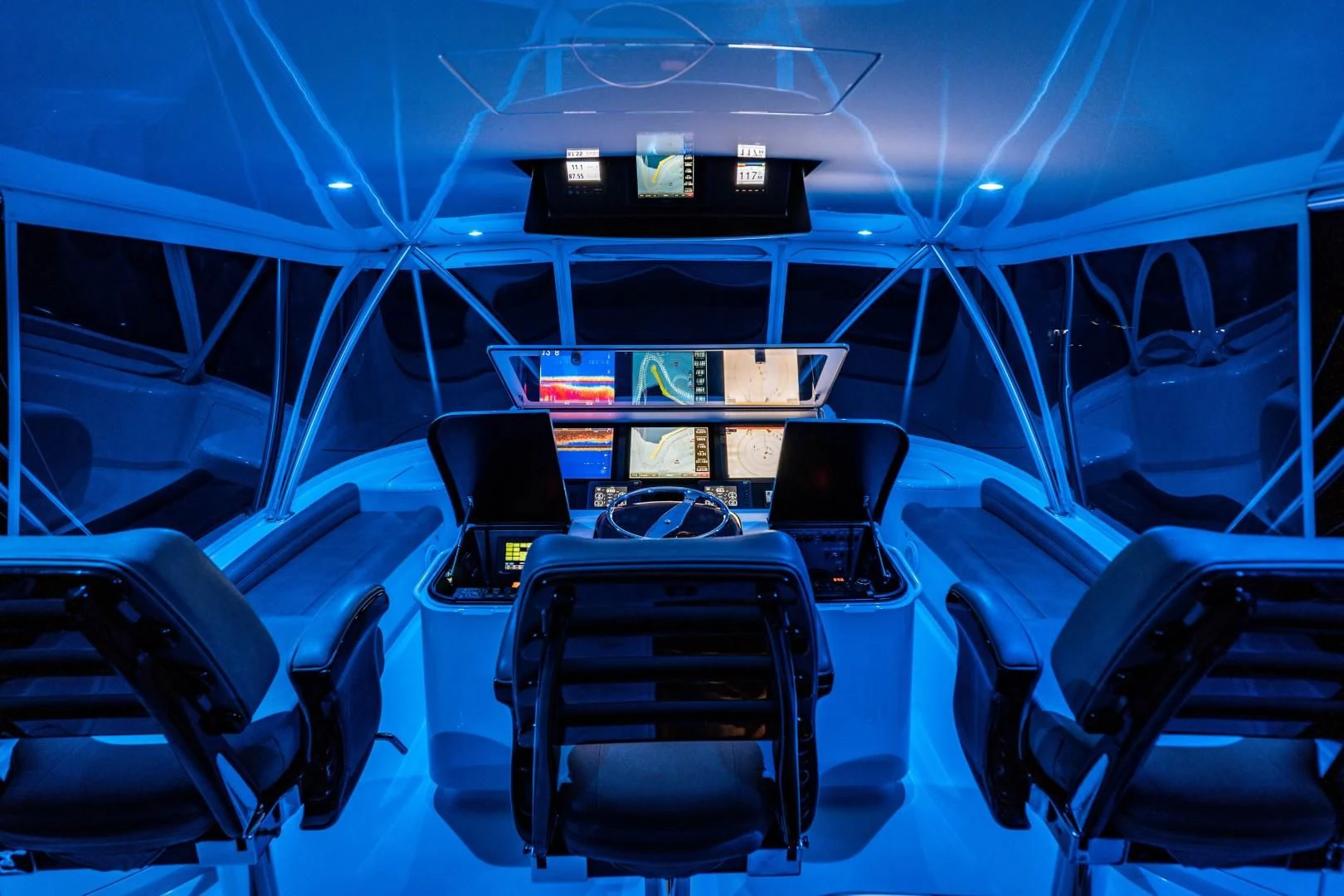 inside of a vehicle with seats and a table and chairs aboard PLAN B Yacht for Sale