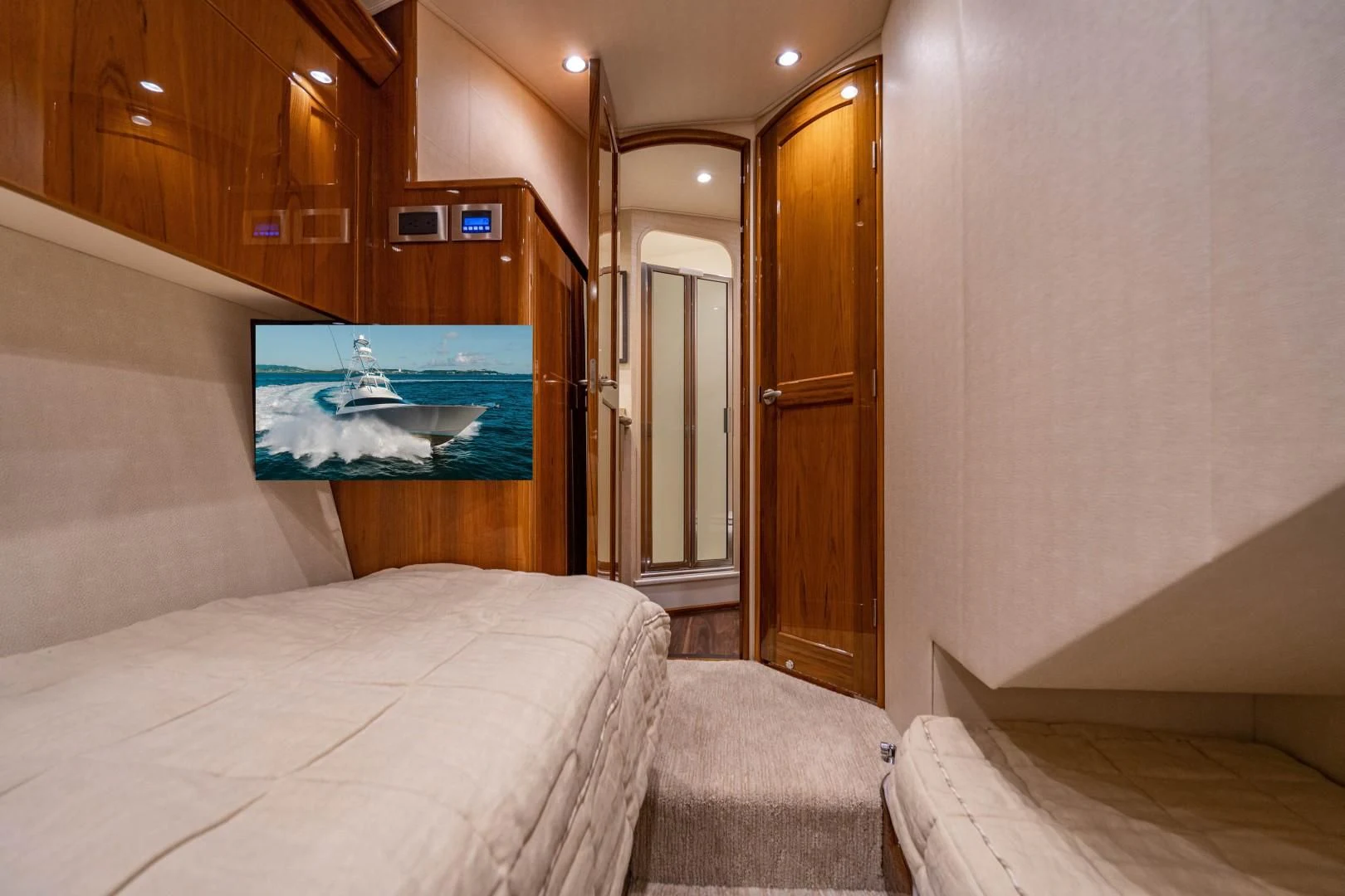 a room with a bed and a painting on the wall aboard PLAN B Yacht for Sale
