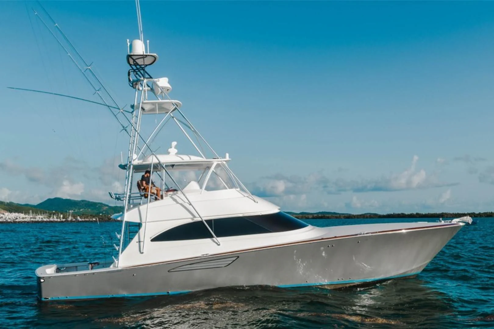 a white boat on the water aboard PLAN B Yacht for Sale