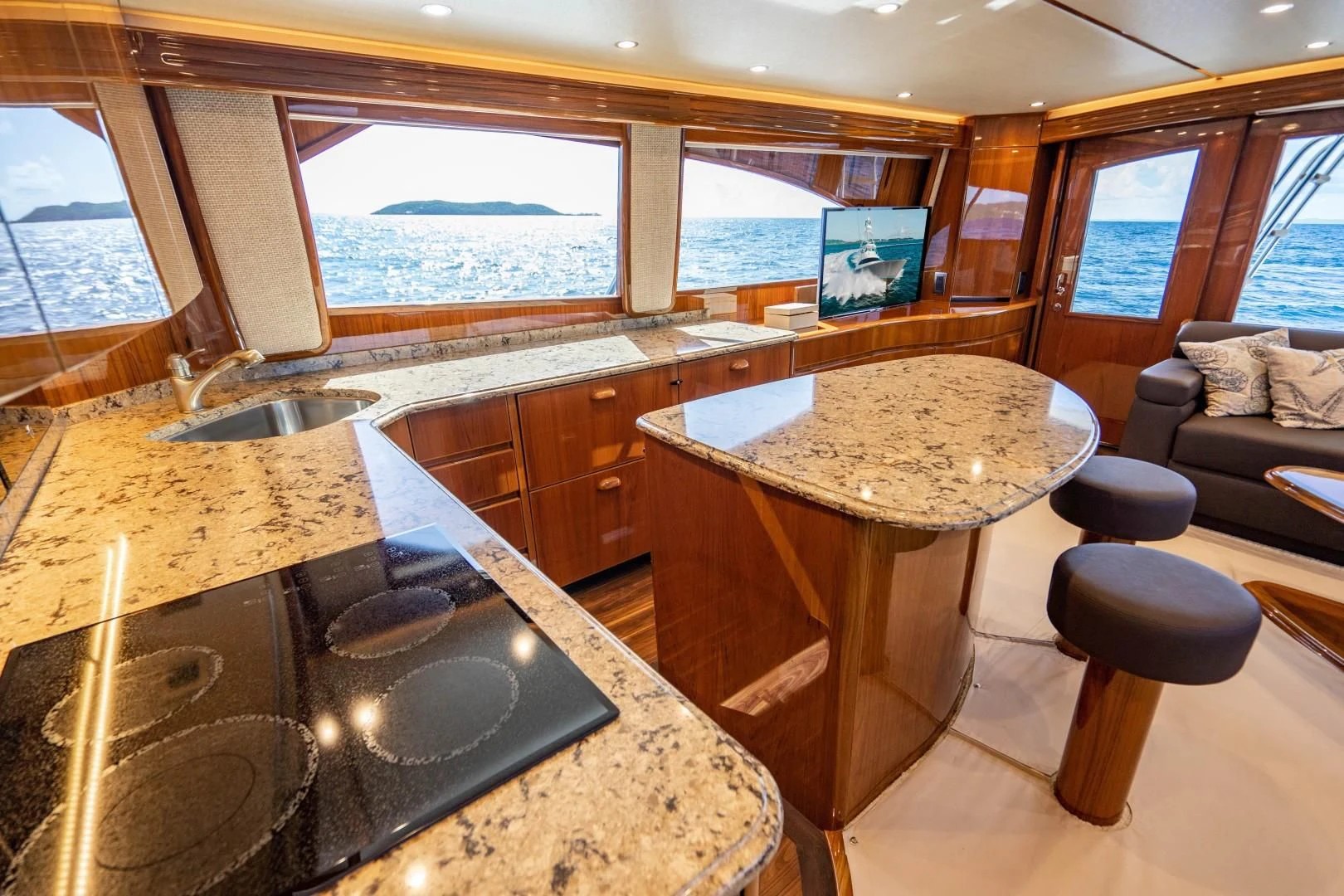 a kitchen with a bar and a table aboard PLAN B Yacht for Sale