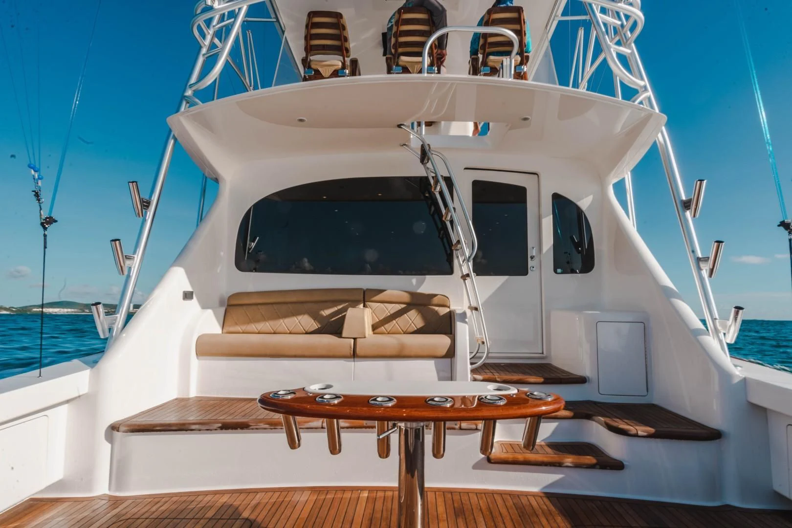 a white boat on a wooden dock aboard PLAN B Yacht for Sale