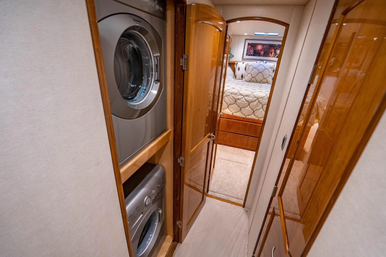 a room with a washing machine and a mirror aboard PLAN B Yacht for Sale