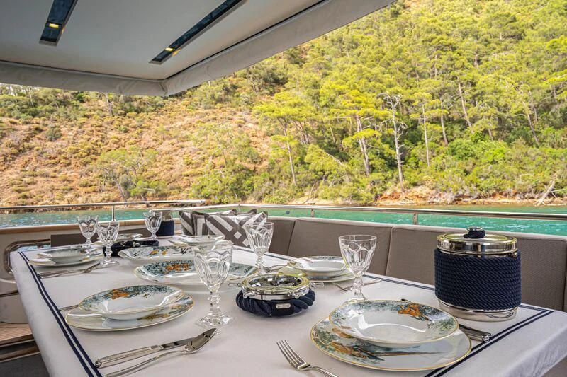 a table with plates and glasses on it aboard SOUTH SEA Yacht for Sale
