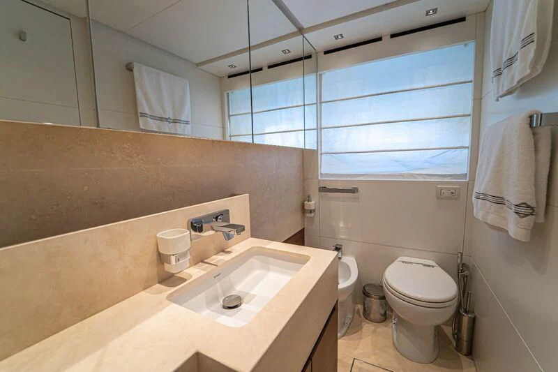 a bathroom with a sink toilet and a mirror aboard SOUTH SEA Yacht for Sale