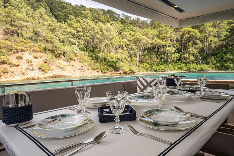 a table with plates and glasses on it aboard SOUTH SEA Yacht for Sale