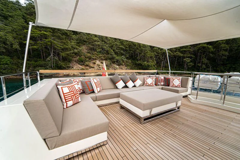 a deck with a couch and a pool aboard SOUTH SEA Yacht for Sale