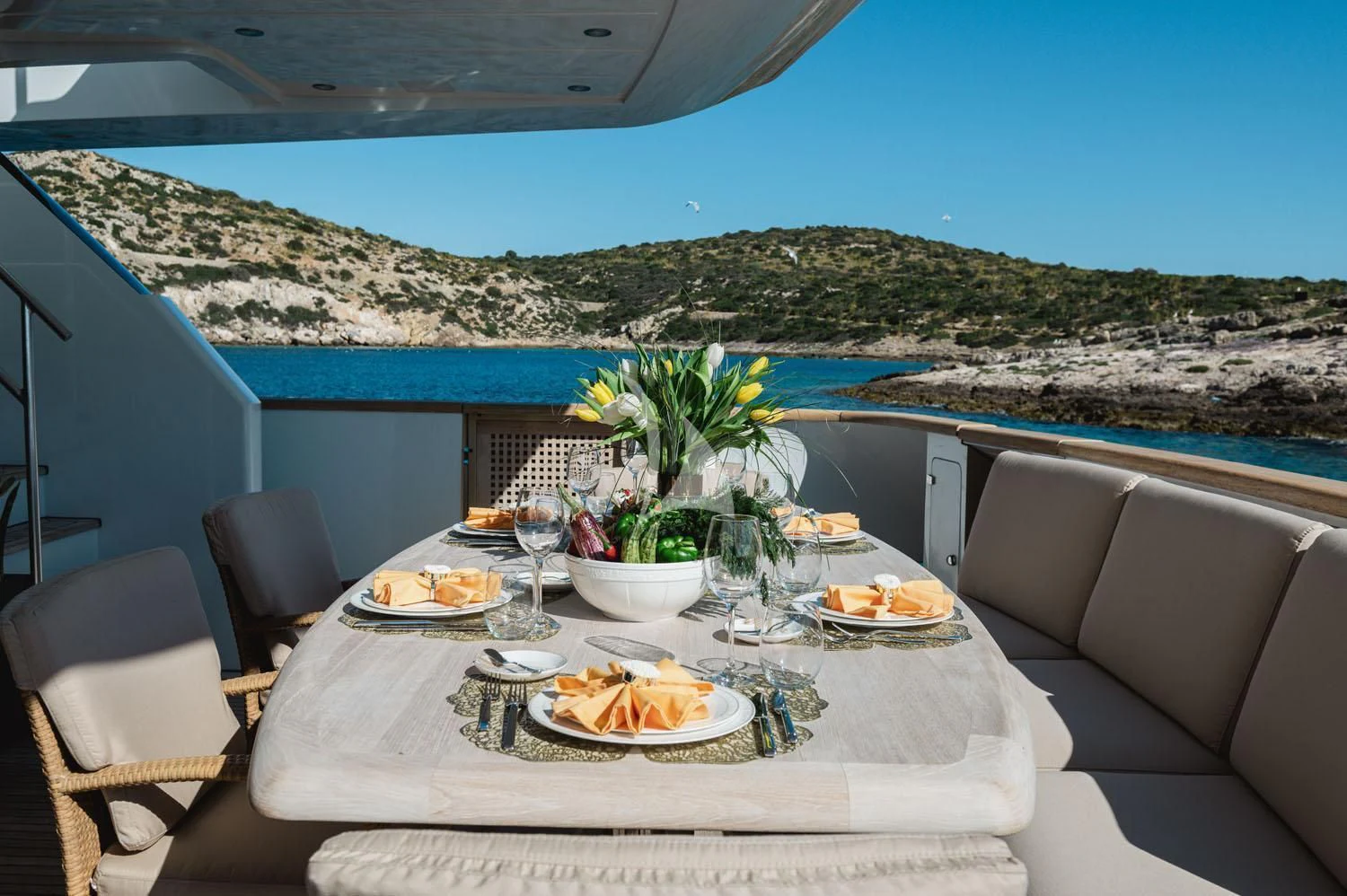 a table with plates and food on it aboard LOANA Yacht for Sale