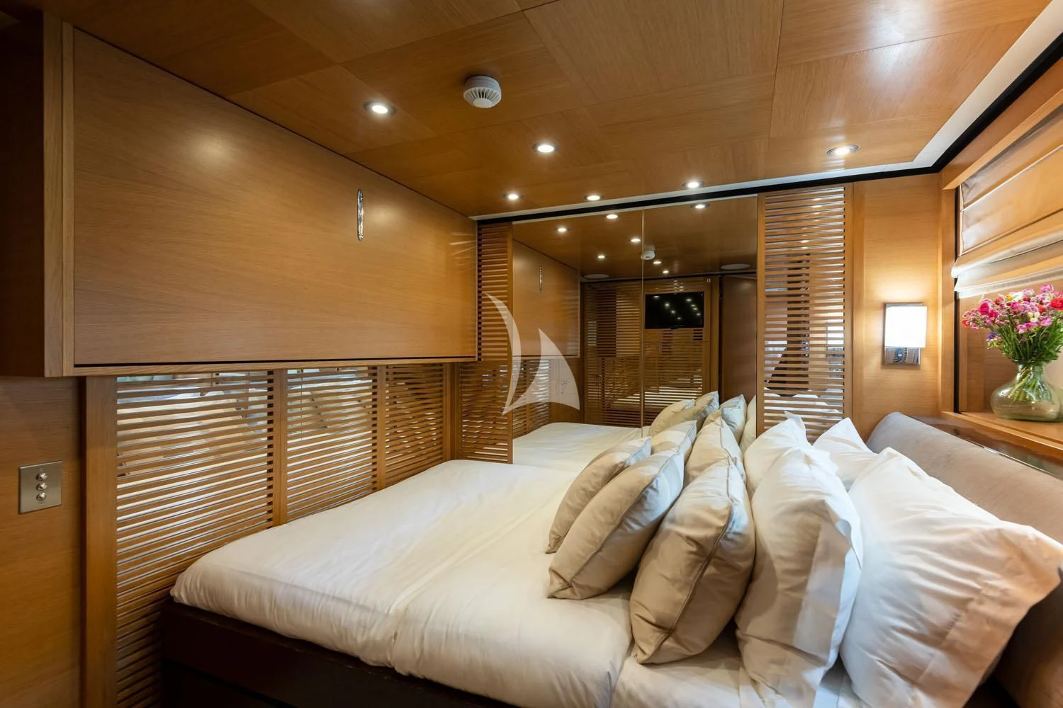 a bed with white sheets aboard LOANA Yacht for Sale