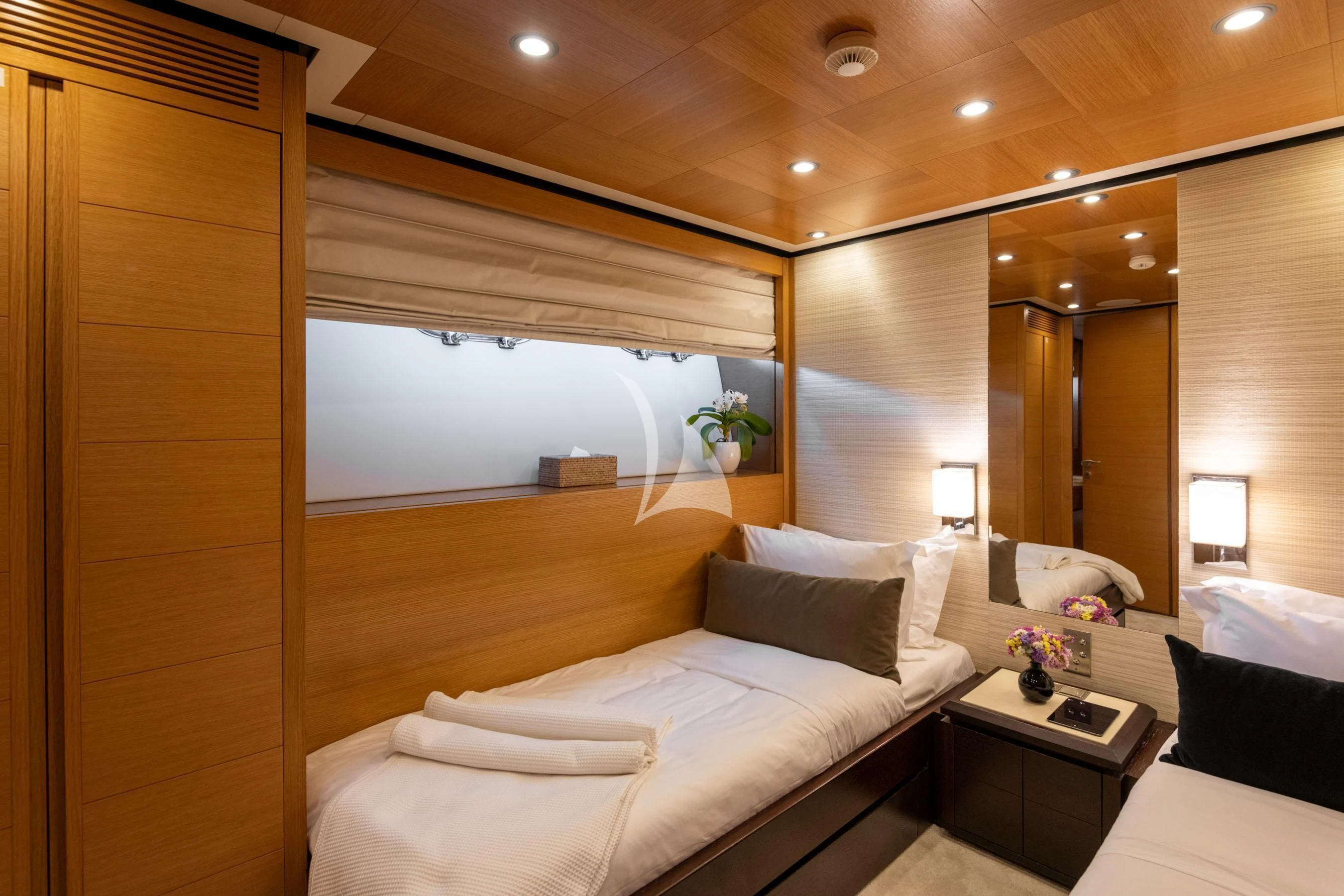 a room with a bed and a mirror aboard LOANA Yacht for Sale