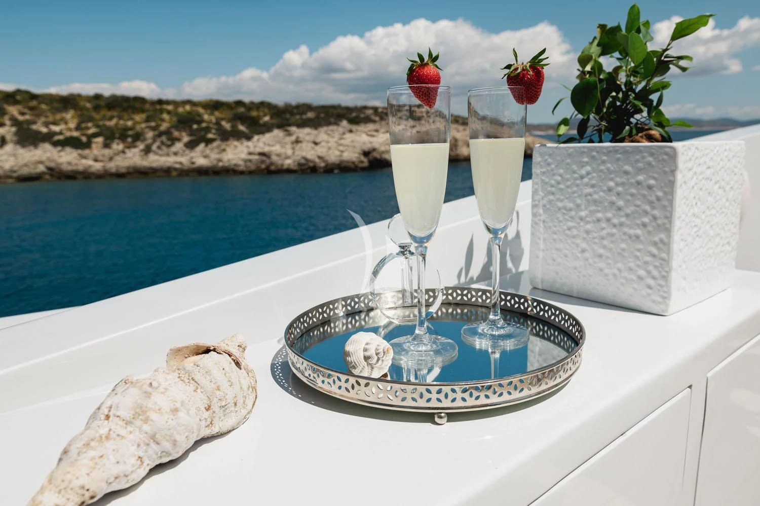 a glass of champagne on a table aboard LOANA Yacht for Sale
