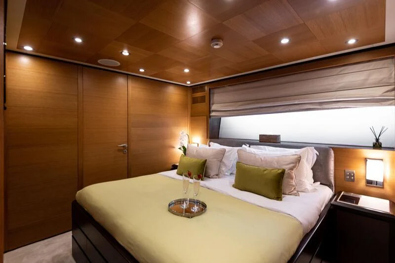 a bed with a white tablecloth aboard LOANA Yacht for Sale