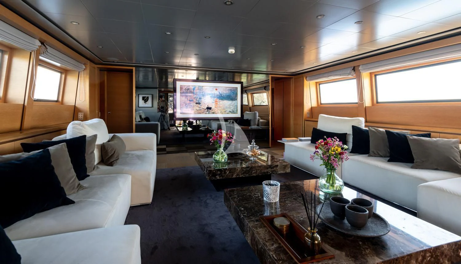 a living room with a large screen aboard LOANA Yacht for Sale
