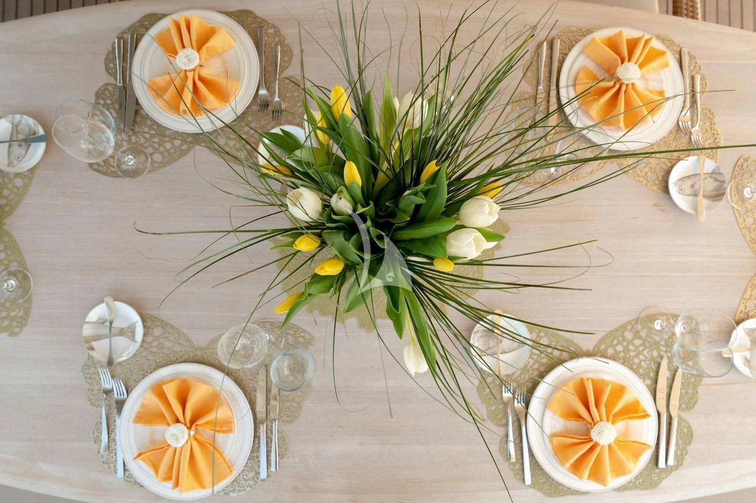a table with a vase of flowers and candles aboard LOANA Yacht for Sale