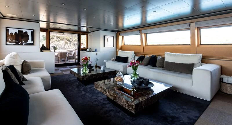 a living room with a couch and a coffee table aboard LOANA Yacht for Sale
