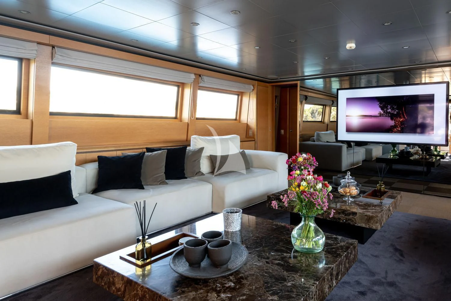 a living room with a large television aboard LOANA Yacht for Sale