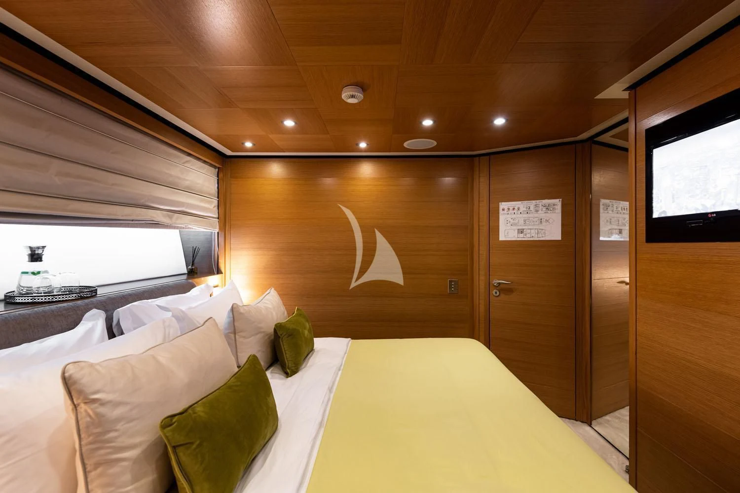 a room with a bed and a window aboard LOANA Yacht for Sale