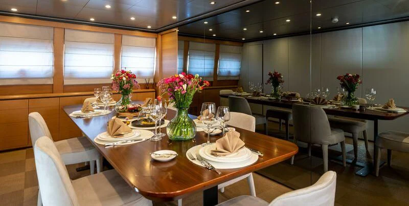 a large dining room with tables and chairs aboard LOANA Yacht for Sale