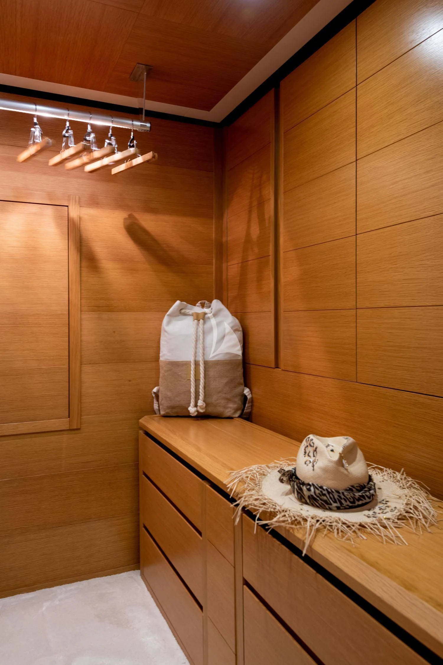 a room with a wood wall and a white bag on a table aboard LOANA Yacht for Sale