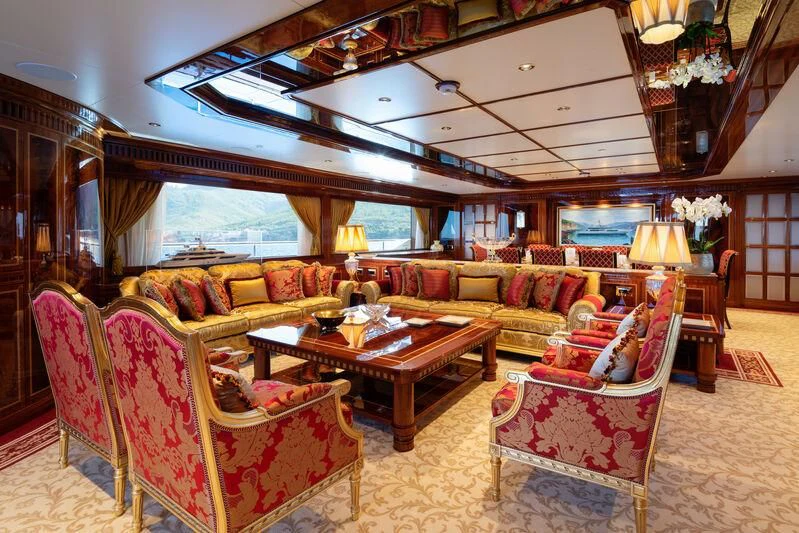 a living room with a large chandelier aboard COCKTAILS Yacht for Sale