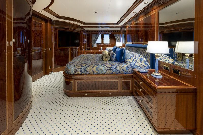 a bedroom with a bed and a dresser aboard COCKTAILS Yacht for Sale