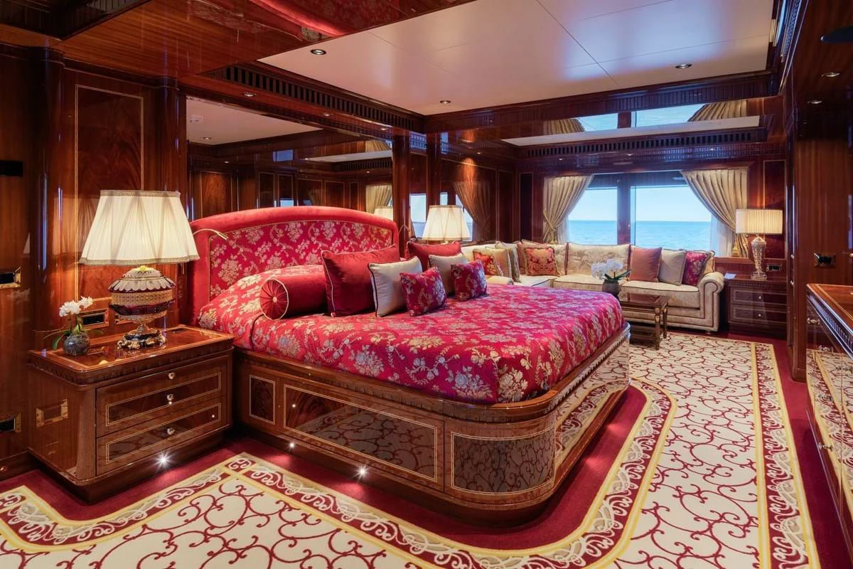 a large bed in a room aboard COCKTAILS Yacht for Sale