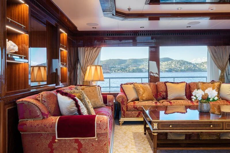 a living room with a couch and a table aboard COCKTAILS Yacht for Sale