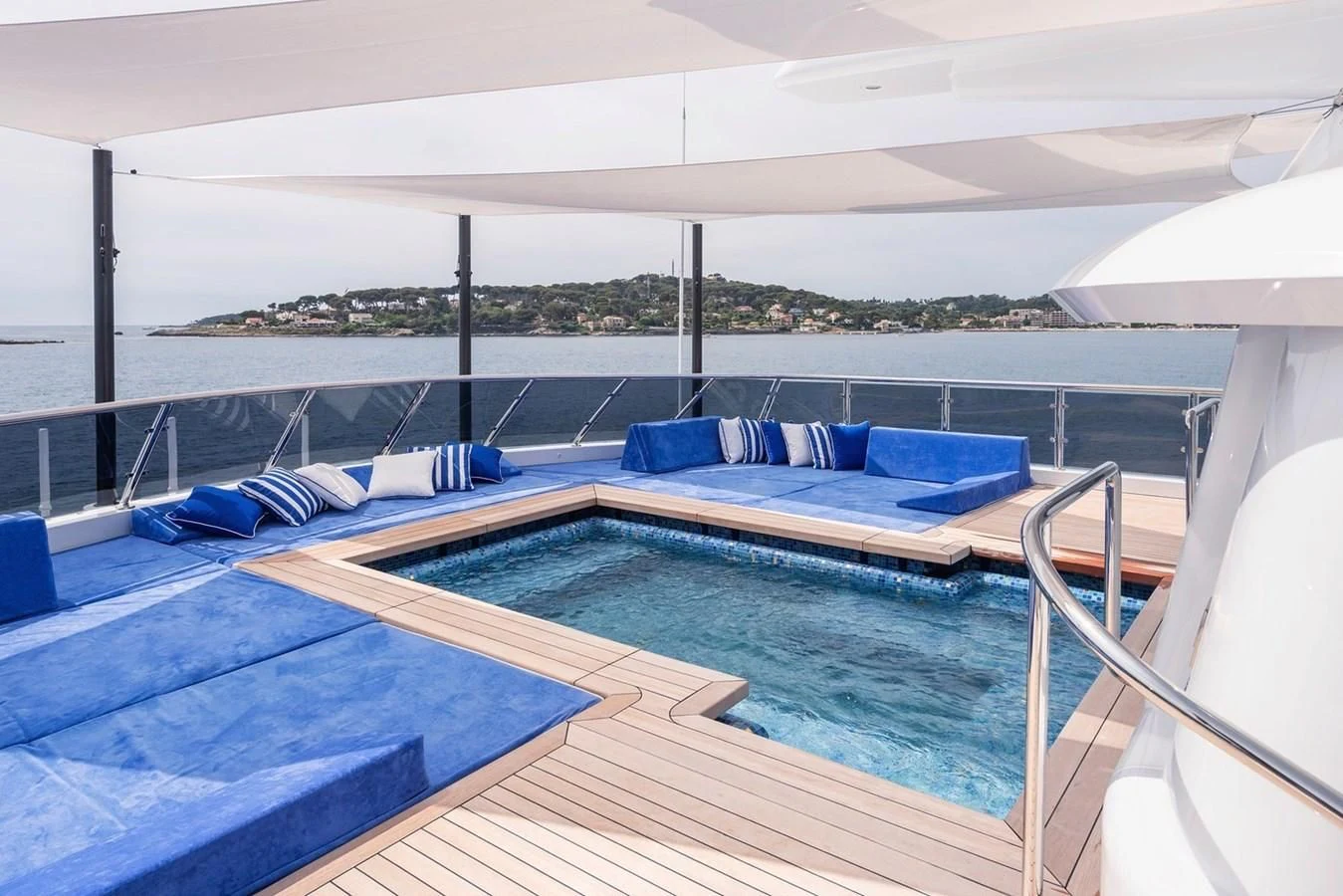 a pool with a deck and a view of the water aboard COCKTAILS Yacht for Sale