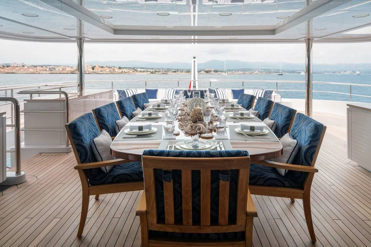a table set for a meal on a deck aboard COCKTAILS Yacht for Sale