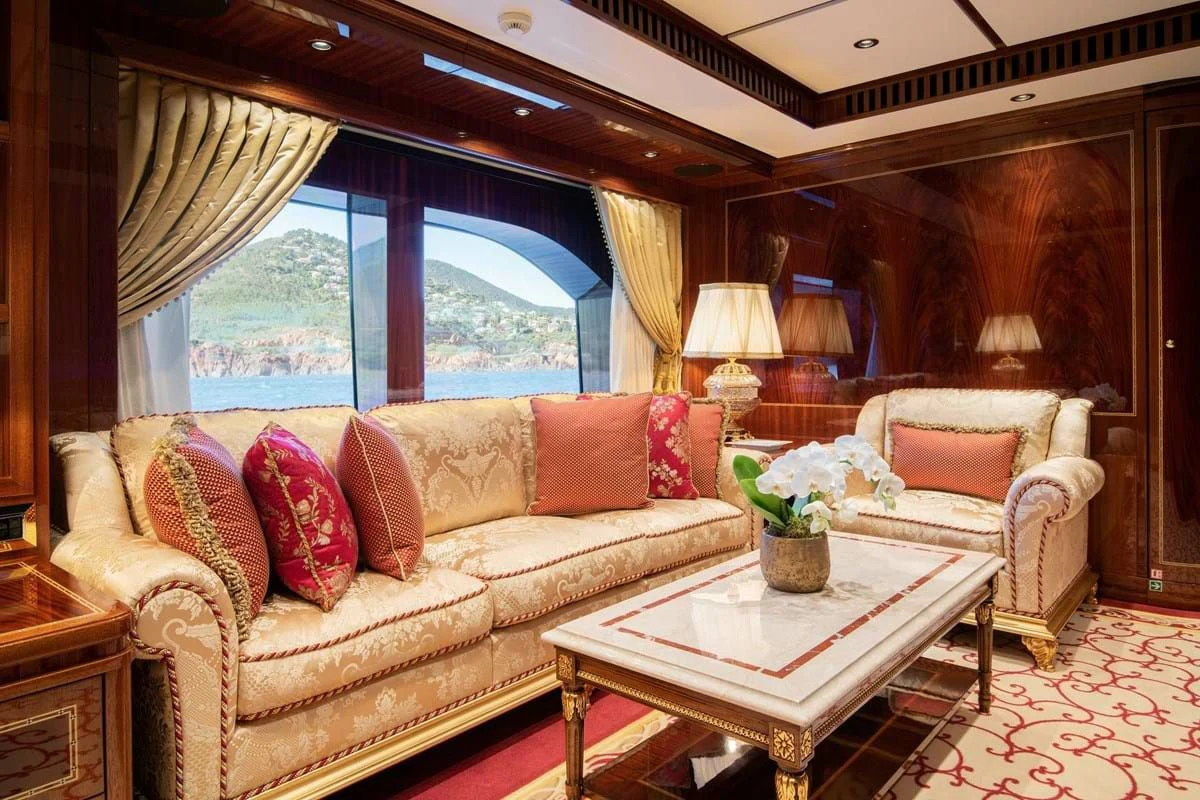 a living room with a couch and a table aboard COCKTAILS Yacht for Sale