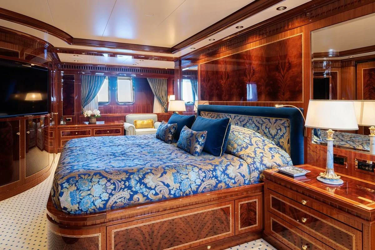 a large bed in a room aboard COCKTAILS Yacht for Sale