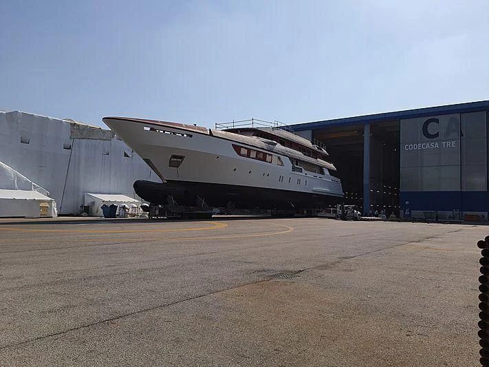 a large white airplane sits in front of a hangar aboard COCKTAILS Yacht for Sale