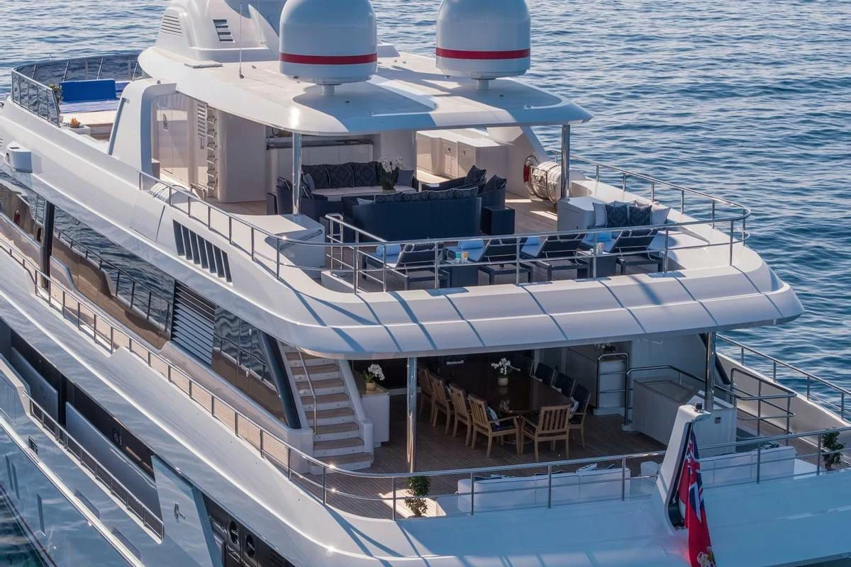 a boat with a deck and chairs on the deck aboard COCKTAILS Yacht for Sale