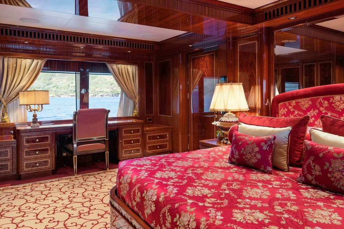 a large bed in a room aboard COCKTAILS Yacht for Sale