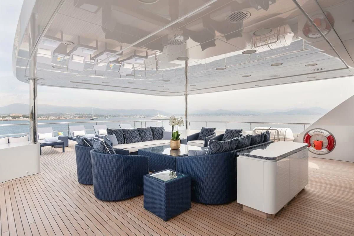 a room with a large white table and chairs and a large white building with a large white roof aboard COCKTAILS Yacht for Sale