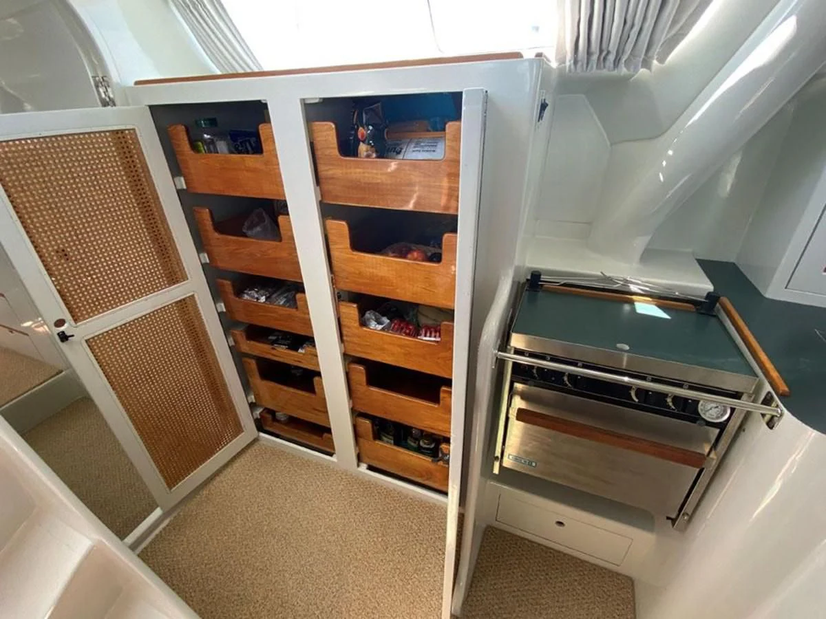 a kitchen with wooden cabinets aboard ROUTE 66 Yacht for Sale