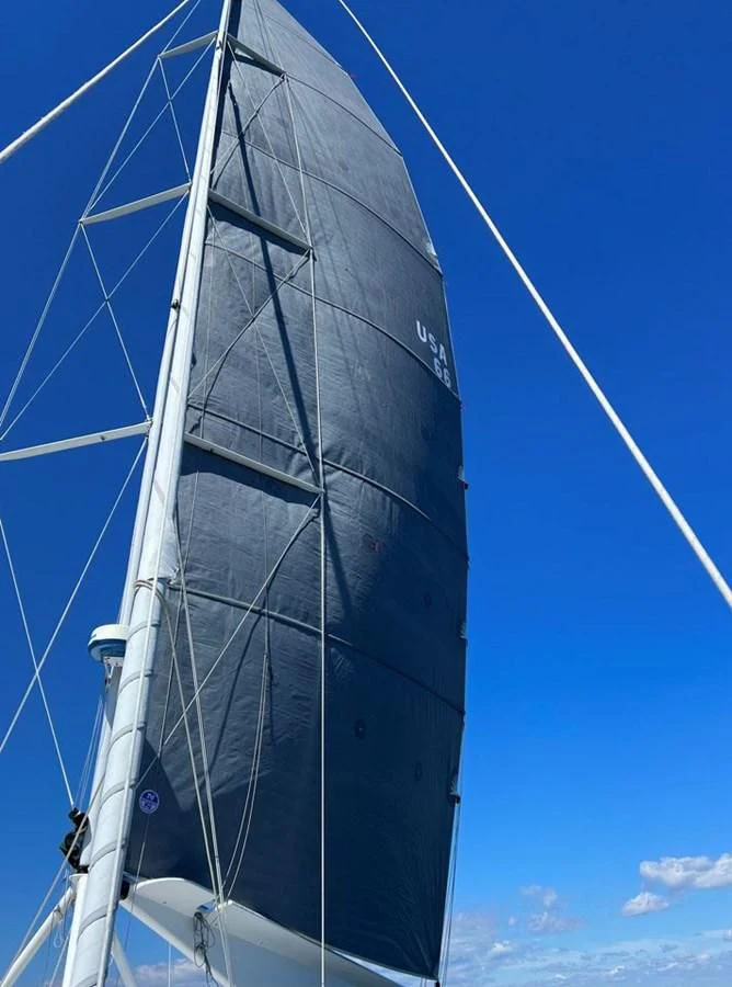 a white sailboat on a blue sky day aboard ROUTE 66 Yacht for Sale