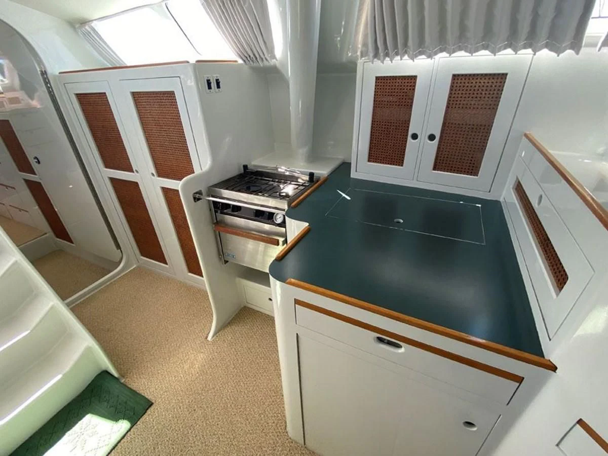 a kitchen with black counter tops aboard ROUTE 66 Yacht for Sale
