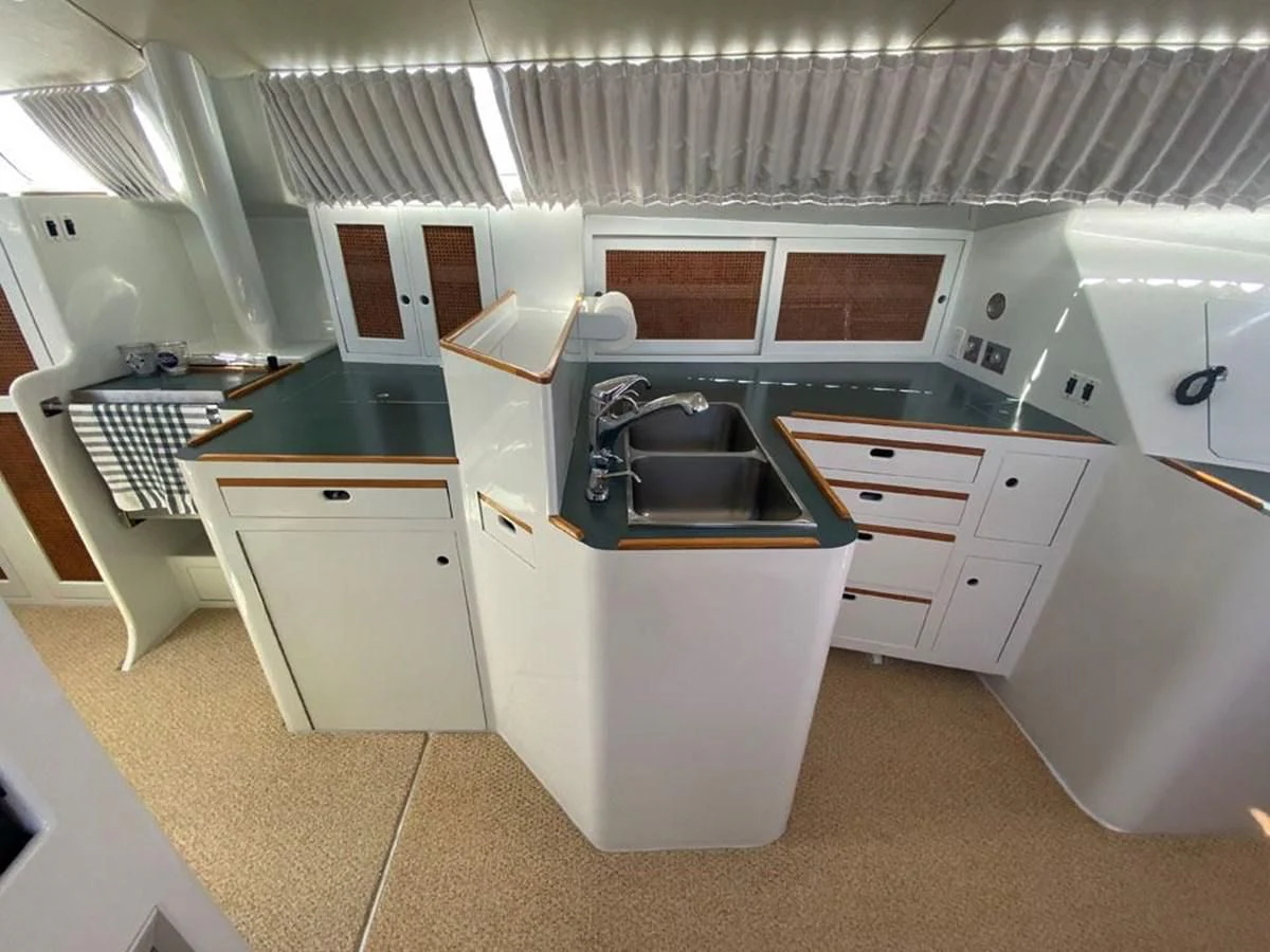 a kitchen with white cabinets aboard ROUTE 66 Yacht for Sale