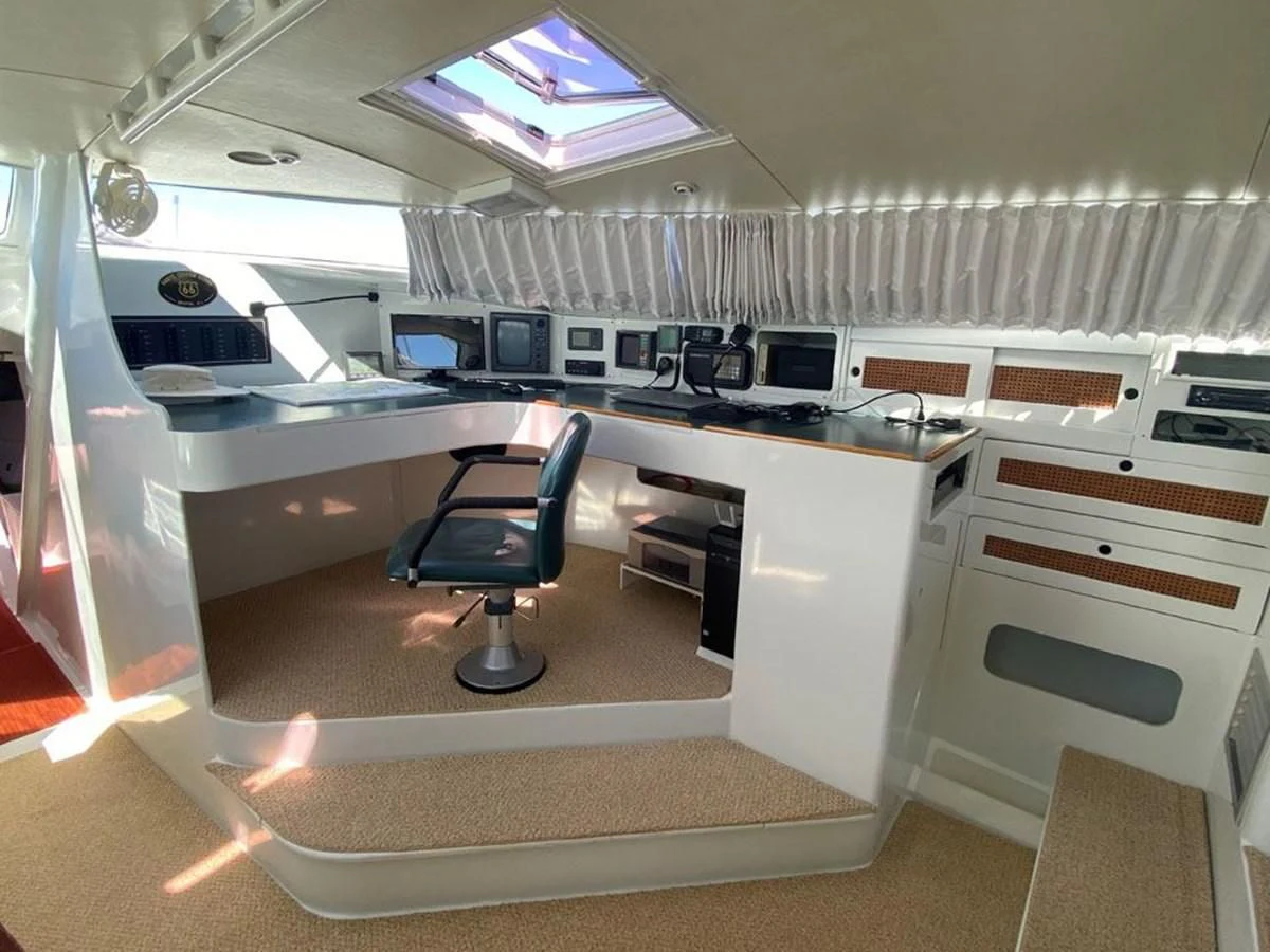 a room with a desk and chairs aboard ROUTE 66 Yacht for Sale