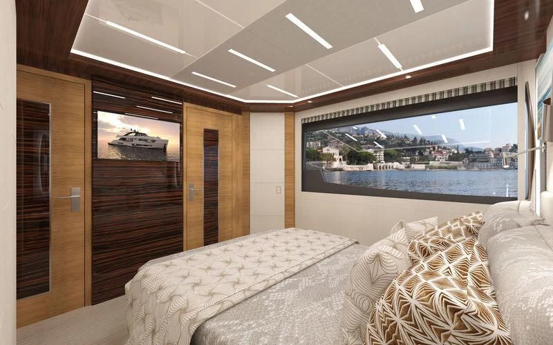 a room with a bed and a large window aboard VOYAGER Yacht for Sale