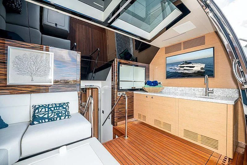 a room with a couch and a television aboard VOYAGER Yacht for Sale