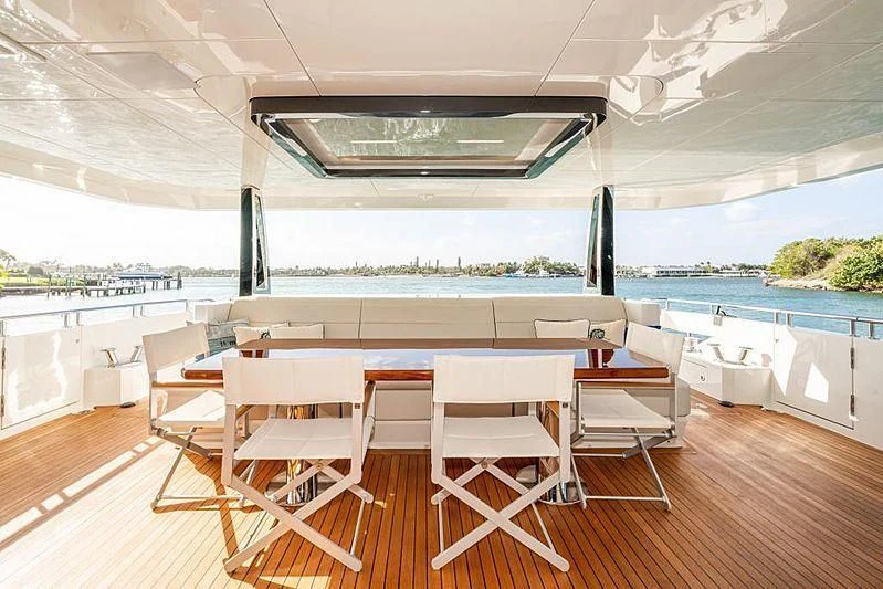 a room with tables and chairs aboard VOYAGER Yacht for Sale