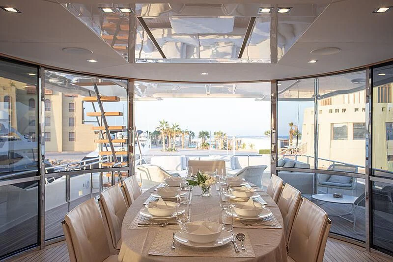 a dining room with a large window aboard MIRA 1 Yacht for Sale